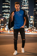 Blue t-shirt on a hanger with a blurred indoor background