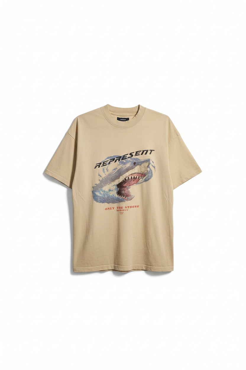 Beige t-shirt with graphic design and text on a hanger indoors