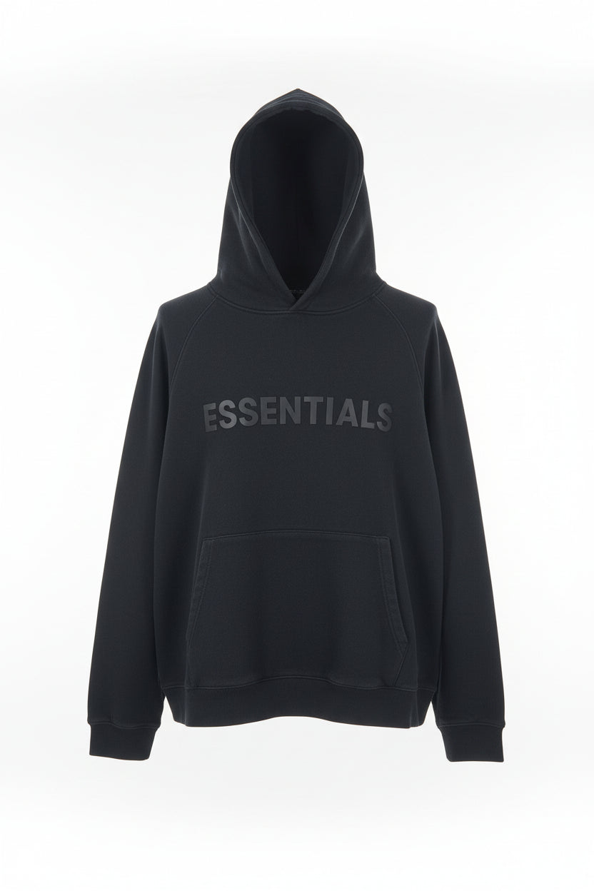 Folded black hoodie with 'ESSENTIALS' text on a patterned surface