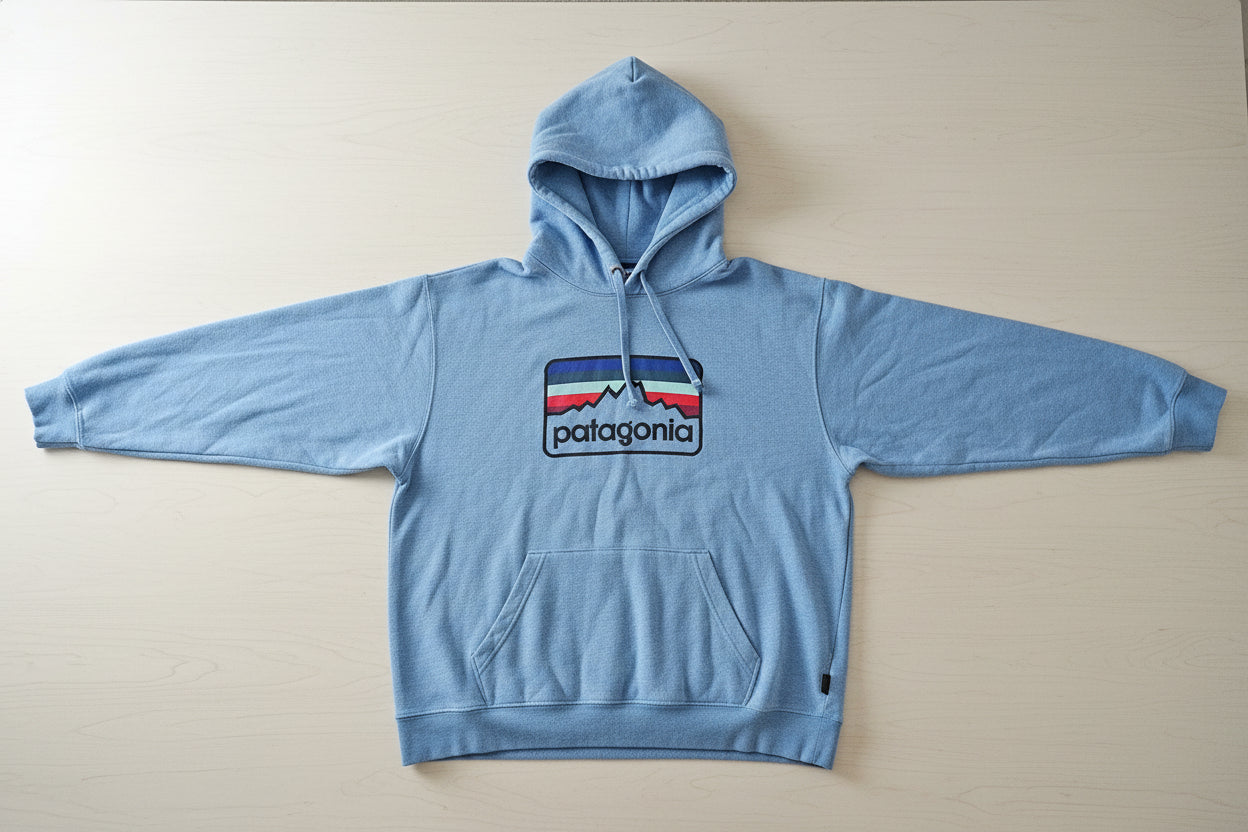 Light blue hoodie with a logo on a rack in a store