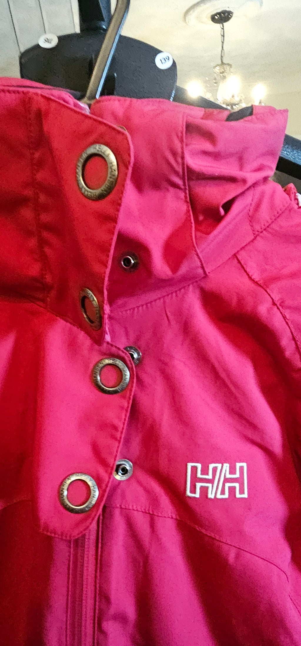Close-up of a red jacket with a brand logo on a blurred background